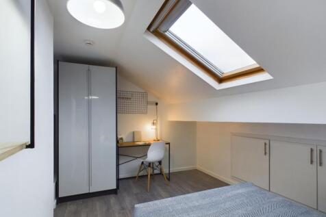 A bright and modern double bedroom featuring a ...
