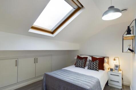 A bright and inviting double bedroom featuring ...