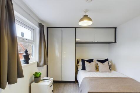 A beautifully organized double bedroom featurin...