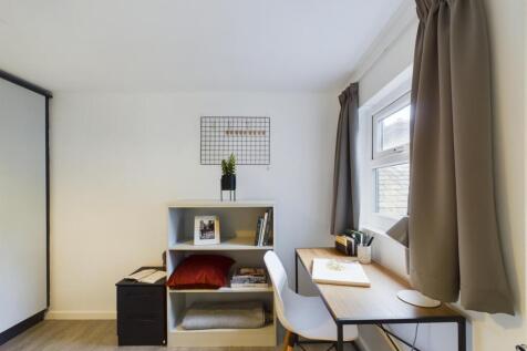 A bright and tidy double bedroom featuring a co...