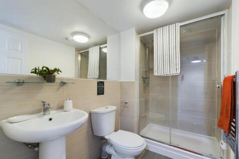A modern and immaculate bathroom featuring a sp...