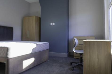 A spacious and well-lit double bedroom, perfect...