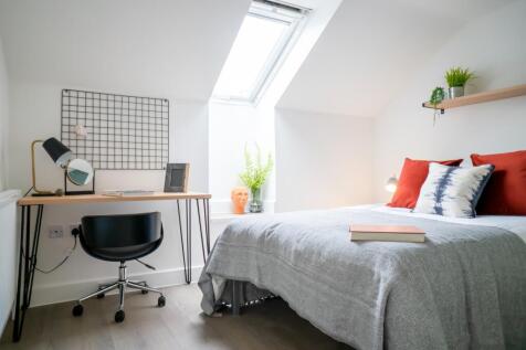 A bright and inviting double bedroom featuring ...