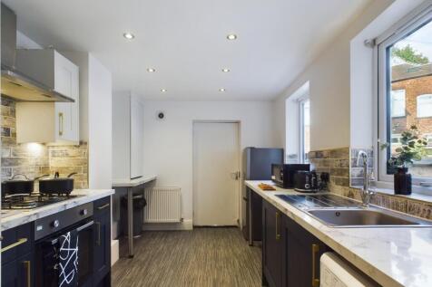 A bright and modern kitchen with ample space fo...