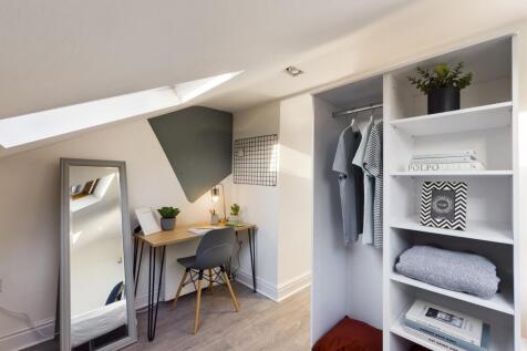 A bright and tidy double bedroom featuring a st...