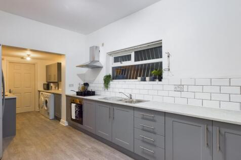 A modern and spacious kitchen with plenty of na...