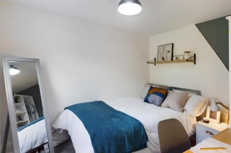 A bright and inviting double bedroom featuring ...