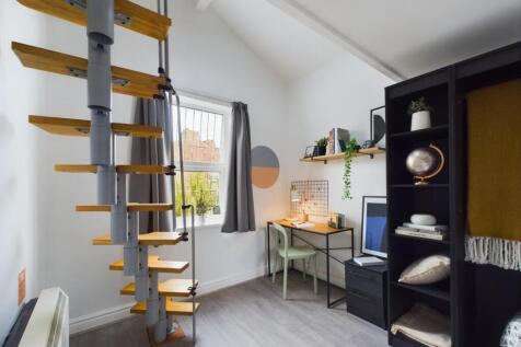 A stylish double bedroom featuring a modern spi...