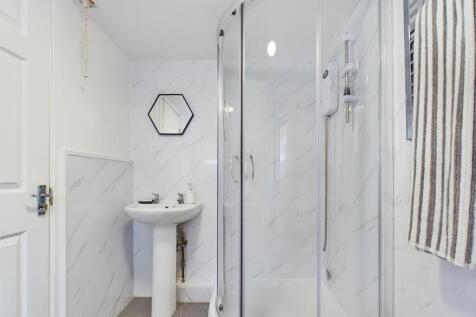 Modern bathroom featuring a stylish shower encl...