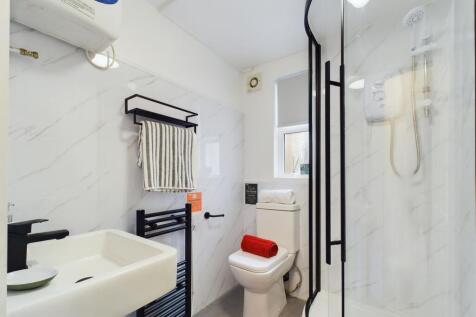 This modern bathroom features a sleek shower, c...