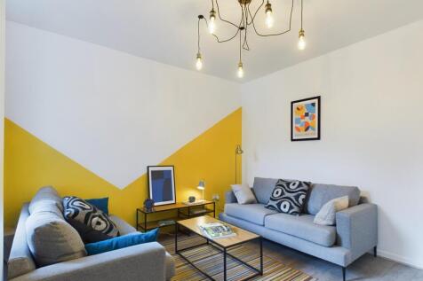 Bright and inviting living room featuring styli...