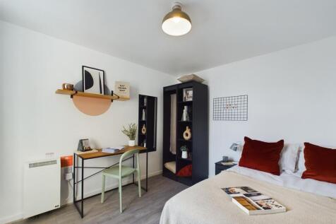 This inviting double bedroom features a cozy be...