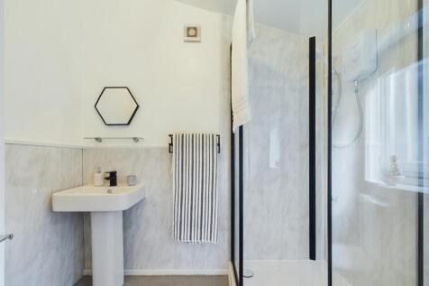 This modern bathroom features a spacious design...