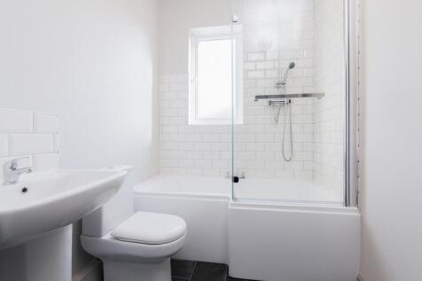 Modern bathroom featuring a stylish bathtub and...