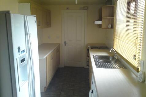 A spacious and tidy kitchenette with ample stor...