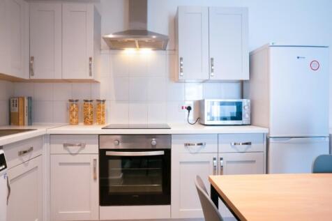 A modern kitchen featuring sleek cabinetry, a b...