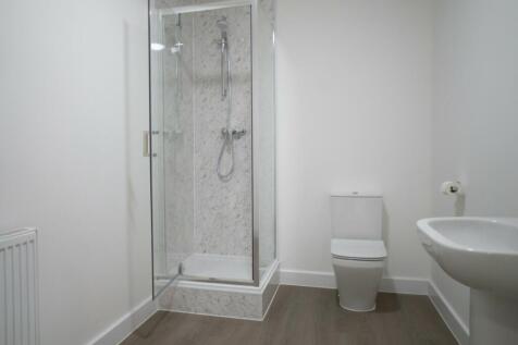 A modern bathroom featuring a stylish shower wi...