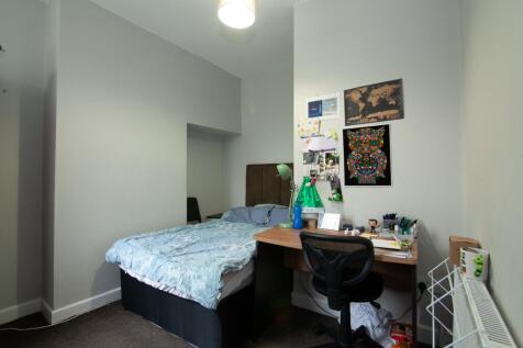 Cozy double bedroom featuring a comfortable bed...