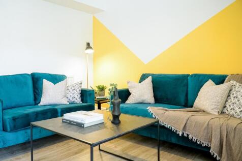 Bright and stylish living room featuring a cont...