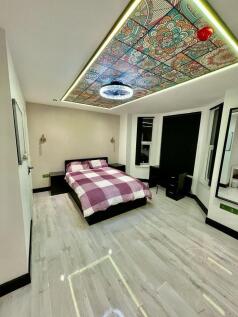 A stylish double bedroom featuring a comfortabl...