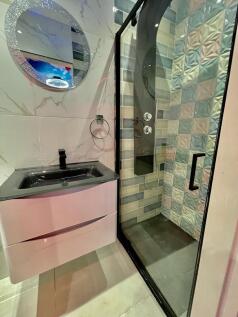 A modern bathroom suite featuring a sleek black...