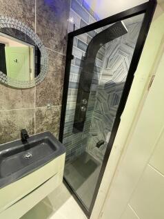 Modern bathroom with a sleek black sink and a c...