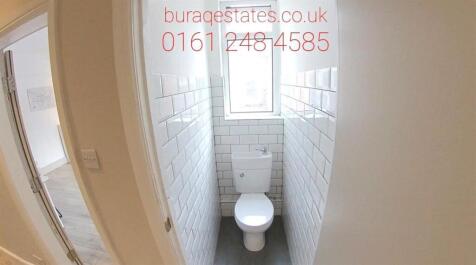 A clean and bright bathroom featuring a standar...