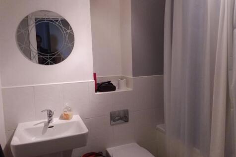 A clean, well-maintained bathroom with a sink, ...