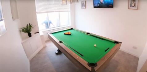 A bright and tidy living room featuring a vibra...