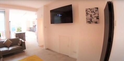 Bright and welcoming living room with ample nat...