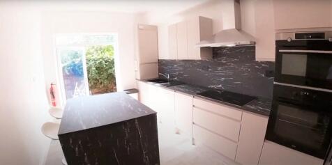 Modern kitchen with sleek cabinetry and a spaci...