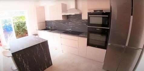 Modern kitchen featuring sleek appliances, ampl...