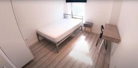 A bright and tidy single bedroom featuring a si...