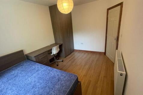 A bright and spacious master bedroom with a lar...