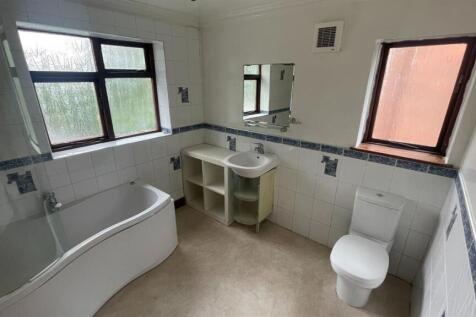 A spacious, well-maintained bathroom featuring ...