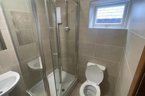 A clean, modern bathroom with a spacious shower...