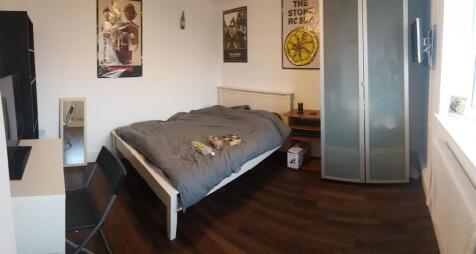 A well-lit, comfortable double bedroom featurin...