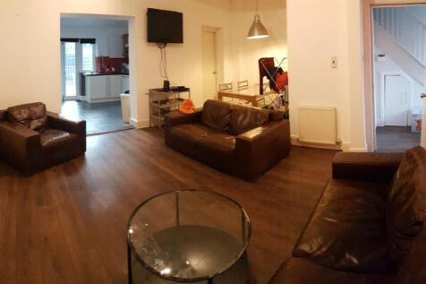 A spacious and well-lit modern living room feat...