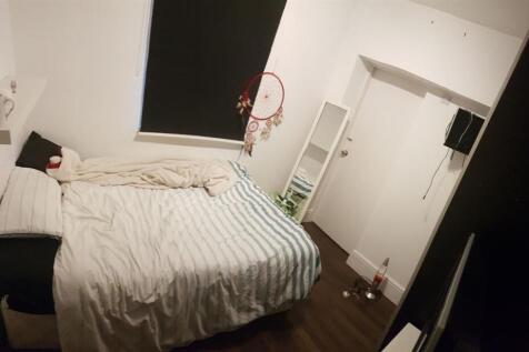 A bright and inviting bedroom featuring a doubl...