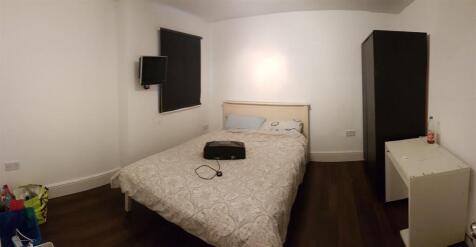 A tidy, well-lit bedroom featuring a double bed...