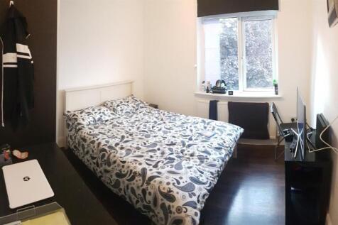 A bright, well-maintained bedroom featuring a d...