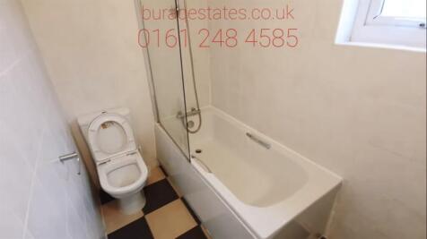 A clean, well-maintained bathroom with a bathtu...