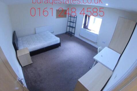 A bright double bedroom featuring a comfortable...