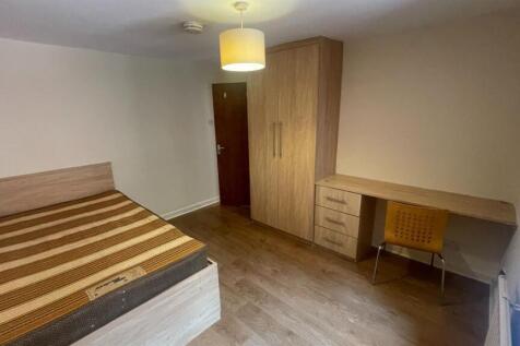 A well-maintained bedroom featuring a double be...