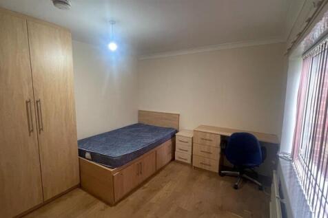 A bright and neatly maintained bedroom featurin...