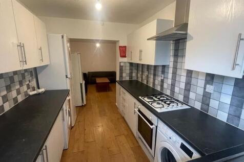 A bright and modern kitchen with white cabinetr...