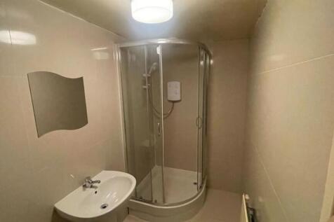 A modern, clean bathroom with a shower enclosur...