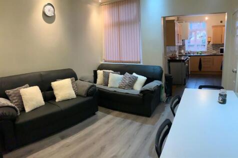 Modern and spacious living room featuring two l...