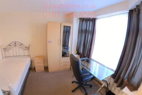 A well-maintained bedroom featuring a spacious ...