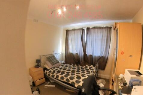 A well-lit bedroom featuring a double bed, fost...